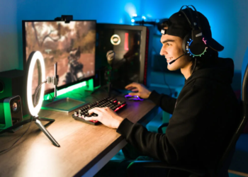 Smiling,young,man,live,streaming,his,online,video,game,using